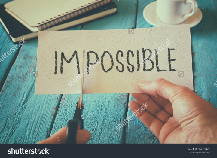 stock-photo-man-hand-holding-card-with-the-text-impossible-cutting-the-word-im-so-it-written-possible-success-384355429